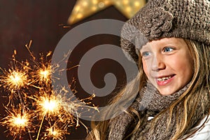 Cute girl looking at festive fire sparks.