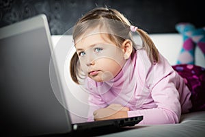 Cute girl looking at laptop