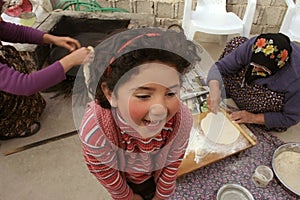 Cute girl loughing while waiting for pastry