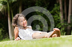 Cute girl lying on grass