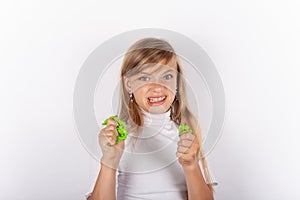 Cute girl making faces while squeezing slimes in her hands