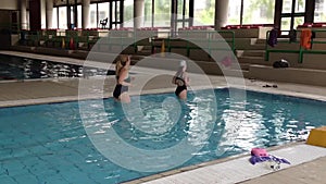 Cute girl with monofin swims in the pool