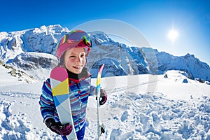 Cute girl with mountain ski outfit stand in snow