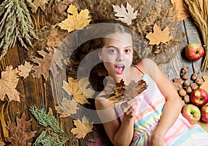 Cute girl with natural blond hair. Small beauty model with fall look. Little girl with wavy hairstyle on fall background