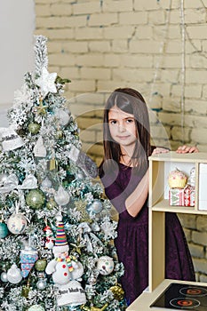 Cute girl near Christmas tree