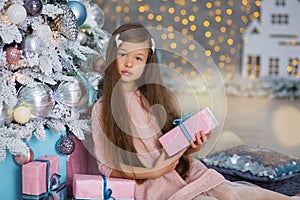 Cute girl near the Christmas tree enjoy miracle winter time. Christmas concept. Belief in miracles