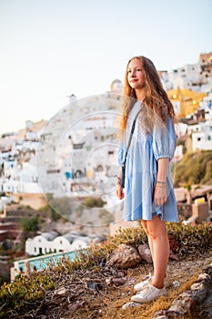 Cute girl in Oia village on Santorini island