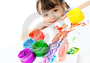 Cute girl painting with finger paints