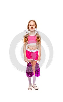 Cute girl in pink cheerleader clothes is standing with shiny pompons in her hands photo