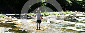 Cute girl playing in a beautiful mountain stream