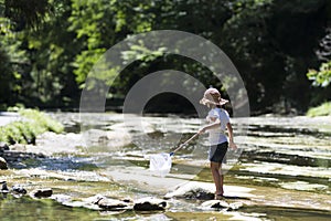 Cute girl playing in a beautiful mountain stream