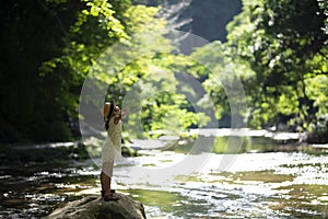 Cute girl playing in a beautiful mountain stream