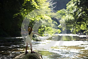 Cute girl playing in a beautiful mountain stream