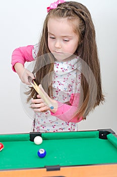 Cute girl playing billiard