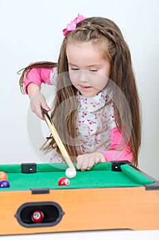 Cute girl playing billiard