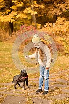 A cute girl playing with her dog in the park