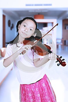 Cute girl playing a music with violin