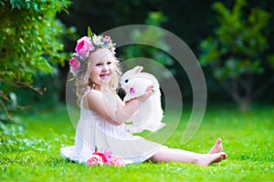 Cute girl playing with real bunny