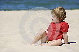 Cute girl playing on a sandy beach