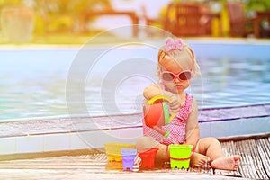 Cute girl playing in swimming pool at tropical