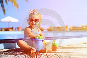 Cute girl playing in swimming pool at tropical