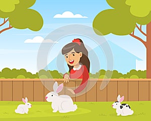 Cute Girl Playing with White Rabbits on Green Lawn, Kid Interacting with Animal in Petting Zoo Cartoon Vector