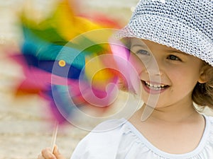 Cute girl playing with windmill