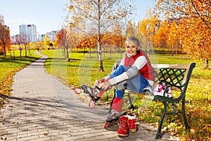 Cute girl putting on roller blades