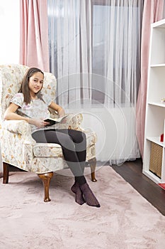 Cute girl read a book, in her room
