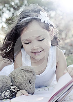 Cute girl reading book