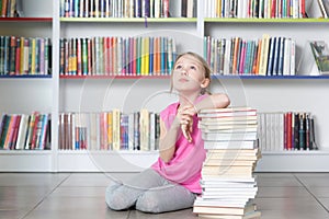 Cute girl reading book in library