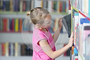 Cute girl reading book in library