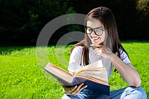 Cute Girl Reading Book Outdoors