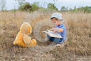 Cute girl reading book Teddy bear