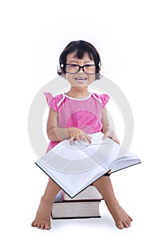 Cute girl reading book on white