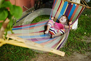 Cute girl resting lying on hammock