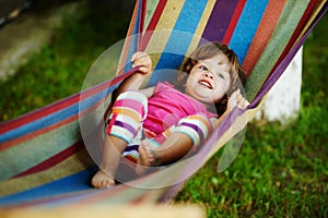 Cute girl resting lying on hammock