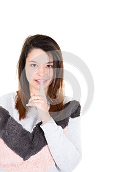 Cute girl showing silence sign holding forefinger on lips having big secret isolated on white background