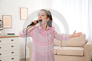 Cute girl singing in microphone