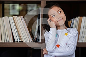 Cute girl sitdown smiled and look up in the room, children concept, education concept