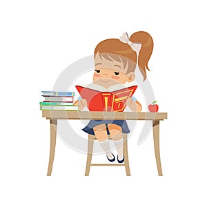 Cute girl sitting at the desk and reading a book, elementary school student in uniform vector Illustration on a white