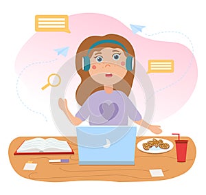 Cute girl is sitting in front of laptop in headphones with food and book on desk
