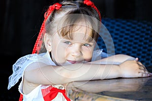 cute girl sitting at a table in kafe in the summer