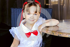 cute girl sitting at a table in kafe in the summer