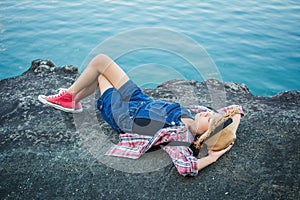 Cute girl sleeping on the rock in nature