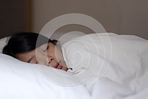 Cute girl sleeping on white pillow at home