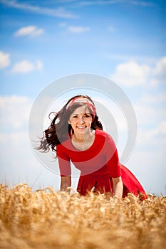 Cute girl in smiling woman in white dress in field