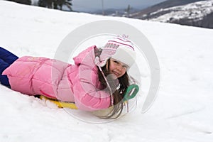 Cute Girl on a Snow Sled