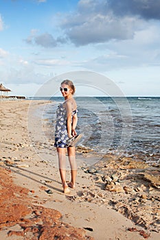 Cute girl standing on the beach