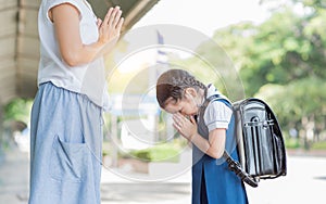 Cute girl student pay respect to her mother